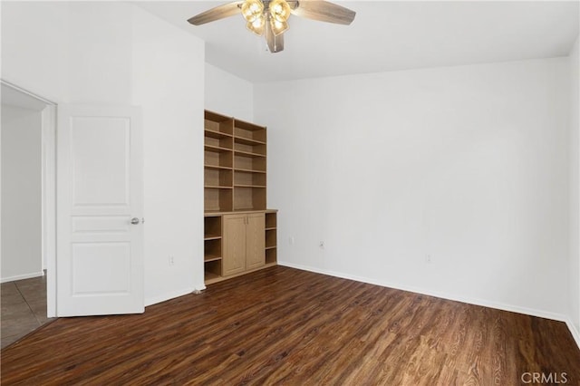 unfurnished bedroom featuring ceiling fan and dark hardwood / wood-style floors