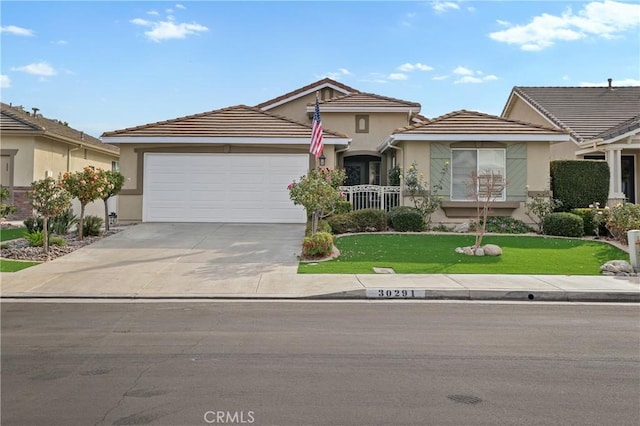 ranch-style home featuring a front yard and a garage