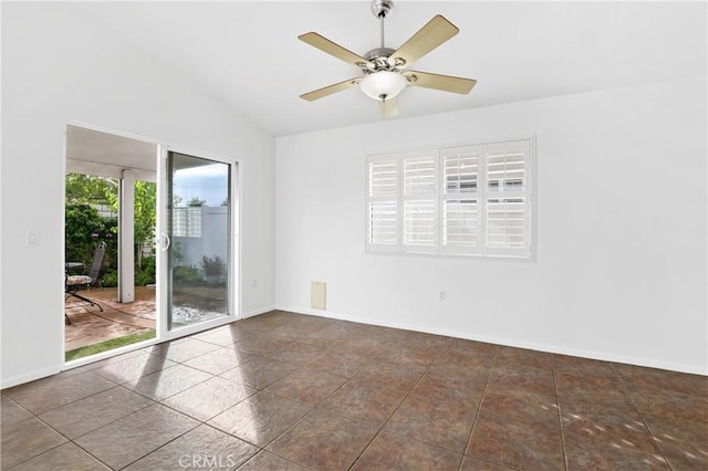 tiled empty room featuring ceiling fan and vaulted ceiling