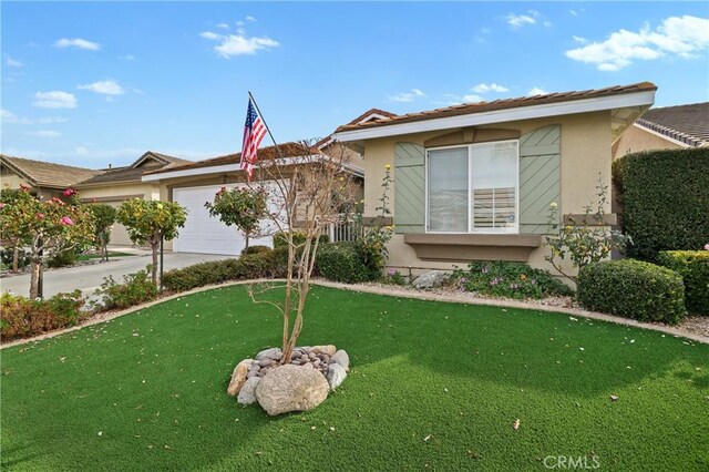 view of front of home featuring a garage and a front lawn