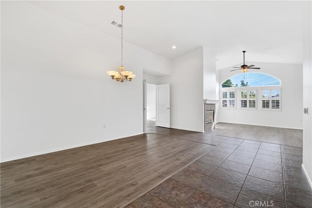 unfurnished living room featuring ceiling fan with notable chandelier, high vaulted ceiling, and dark hardwood / wood-style floors