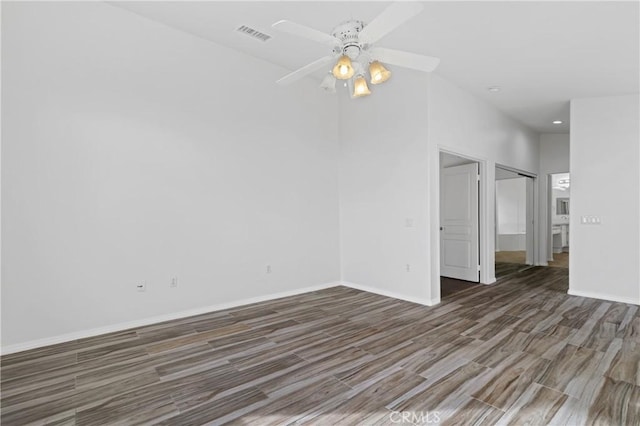 spare room featuring dark hardwood / wood-style floors and ceiling fan