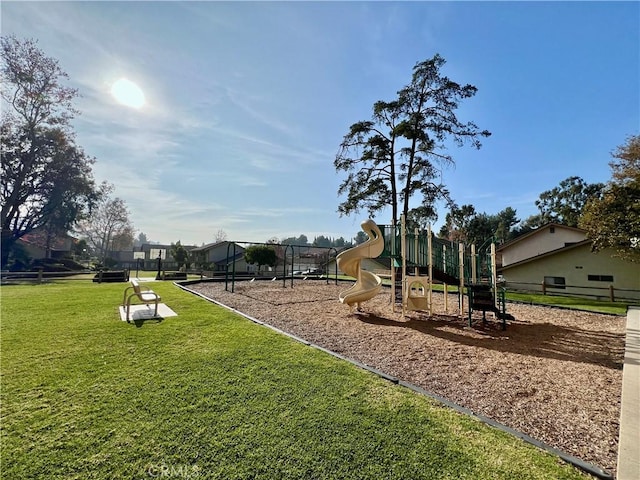 view of jungle gym featuring a lawn