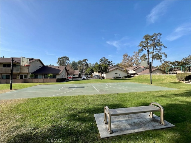 view of basketball court with a lawn