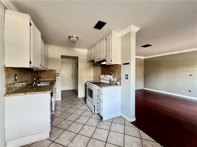 kitchen with sink, backsplash, white electric stove, and white cabinetry