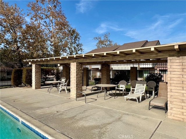 view of patio with a fenced in pool and a pergola