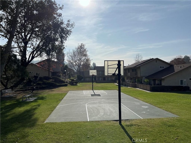 view of sport court featuring a yard