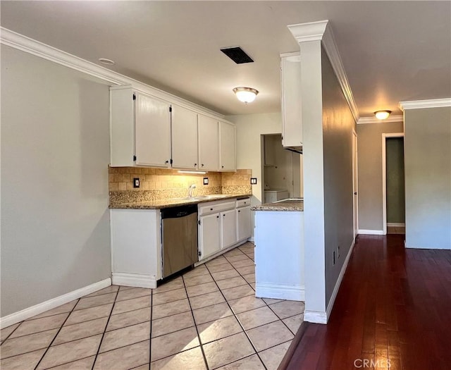 kitchen featuring light stone countertops, dishwasher, white cabinetry, tasteful backsplash, and ornamental molding