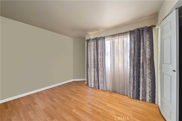 unfurnished room with hardwood / wood-style floors