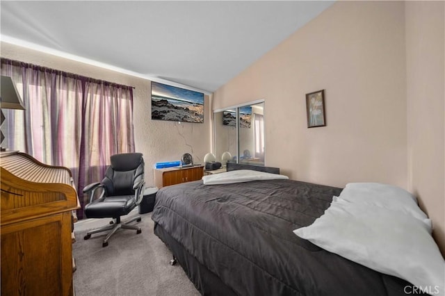 carpeted bedroom with lofted ceiling