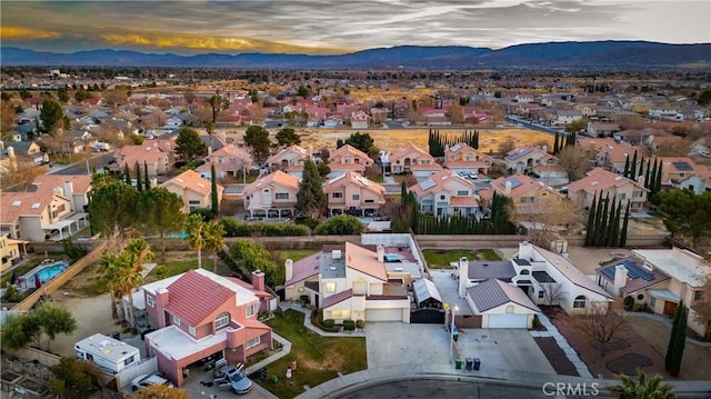 aerial view at dusk featuring a mountain view