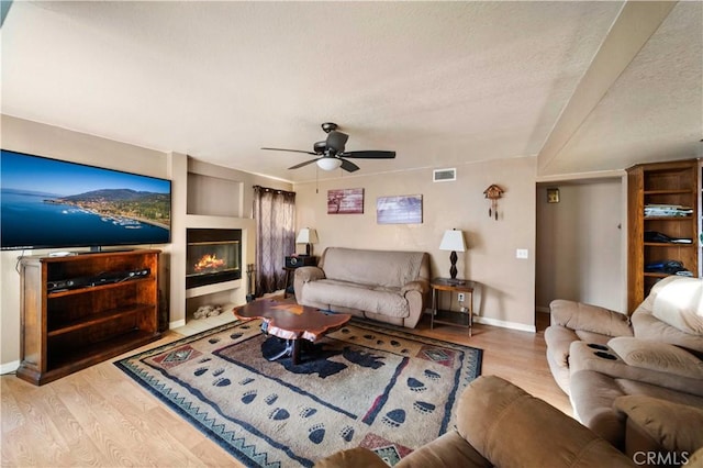 living room with ceiling fan and light hardwood / wood-style floors