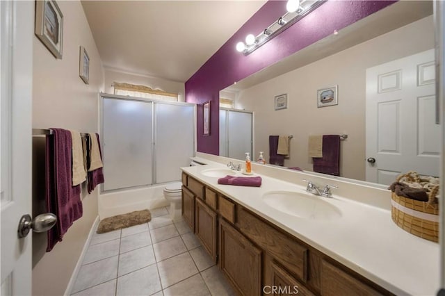 full bathroom featuring toilet, tile patterned flooring, enclosed tub / shower combo, and vanity