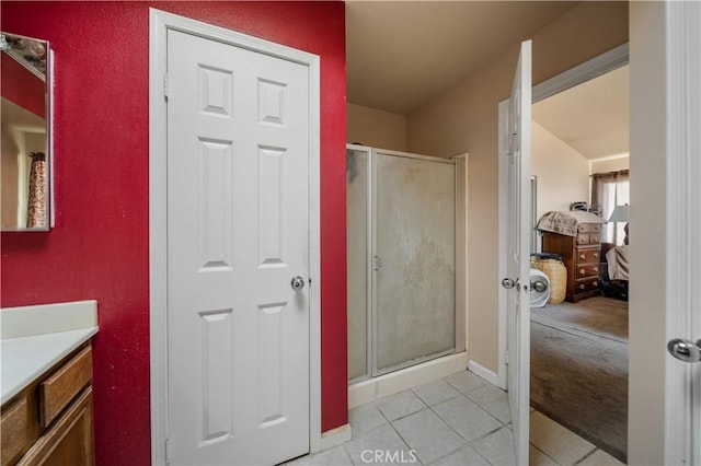 bathroom featuring tile patterned floors, walk in shower, and vanity