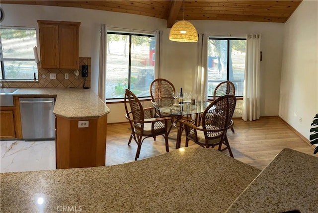 dining room featuring wooden ceiling, a healthy amount of sunlight, lofted ceiling with beams, and light wood-type flooring