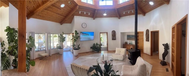 living room featuring high vaulted ceiling, a wealth of natural light, and wooden ceiling