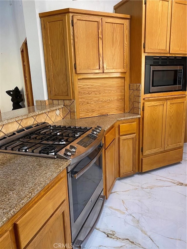 kitchen featuring tasteful backsplash and stainless steel appliances