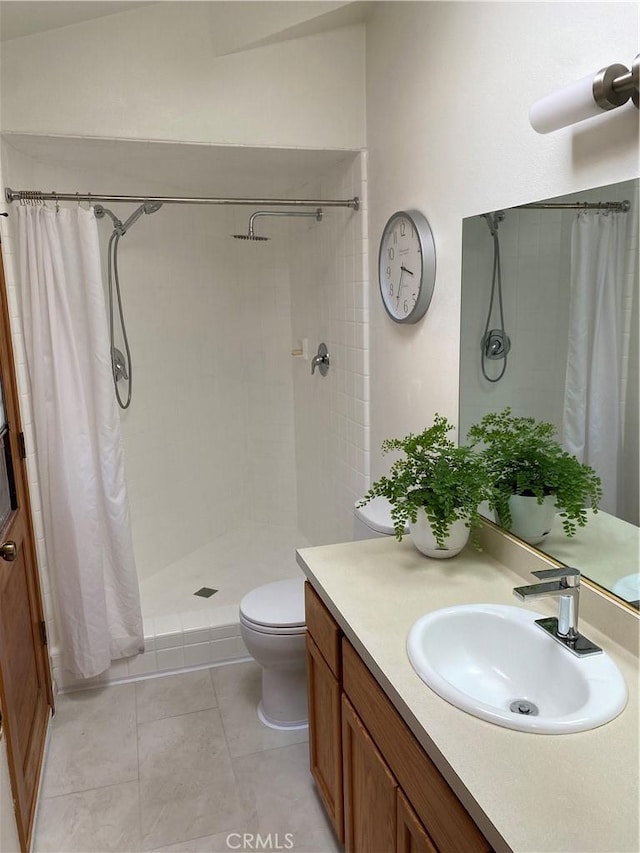 bathroom featuring curtained shower, toilet, vanity, and tile patterned flooring