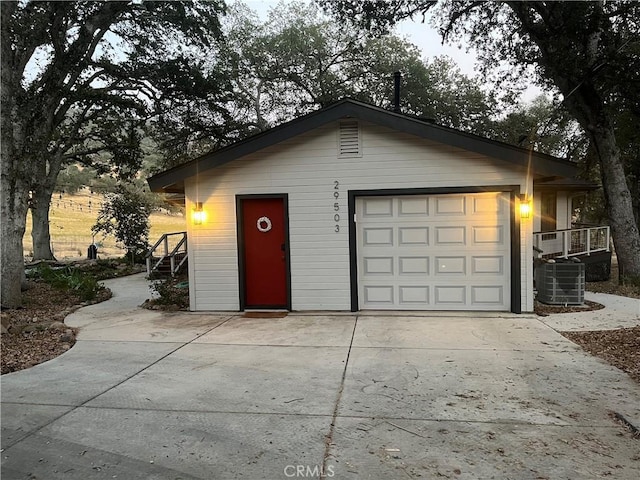 garage at dusk with cooling unit