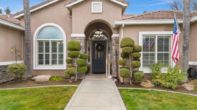 property entrance with a yard