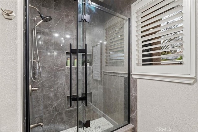 bathroom with a shower with door