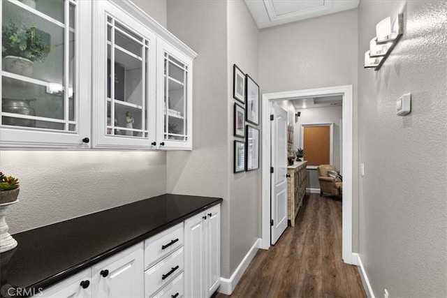 hallway with dark wood-type flooring