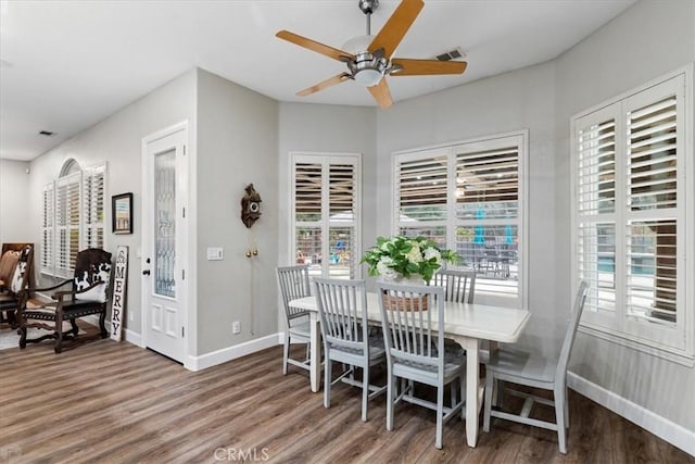 dining space with ceiling fan and hardwood / wood-style floors