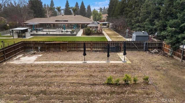 view of yard featuring a pool and a gazebo