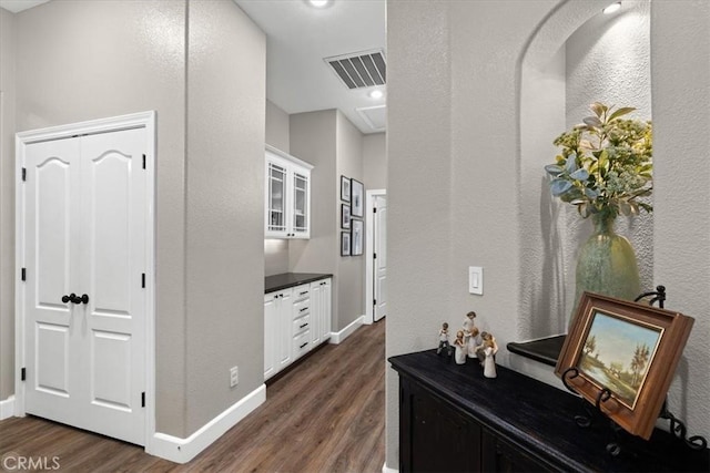 hall with dark wood-type flooring