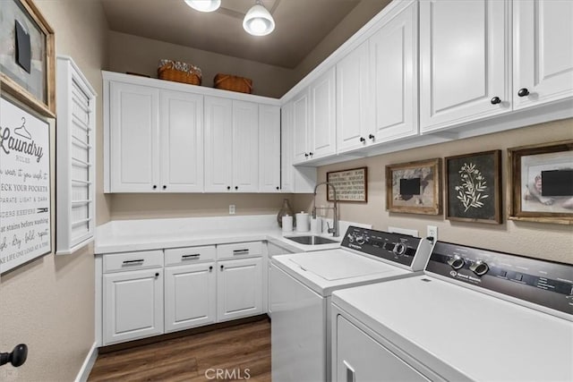 washroom featuring cabinets, sink, independent washer and dryer, and dark wood-type flooring