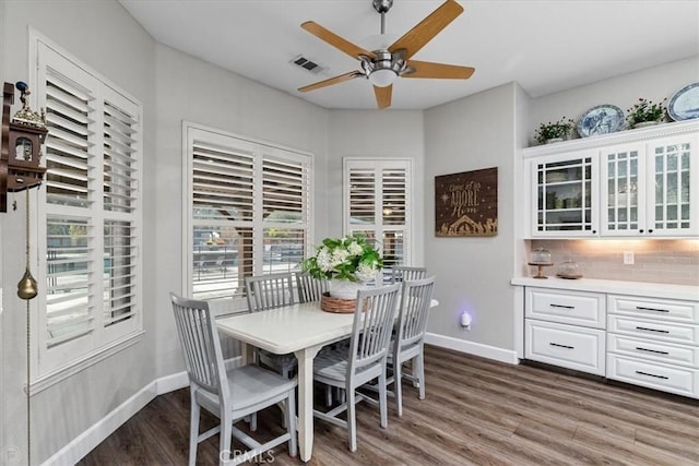 dining room with ceiling fan and dark hardwood / wood-style floors