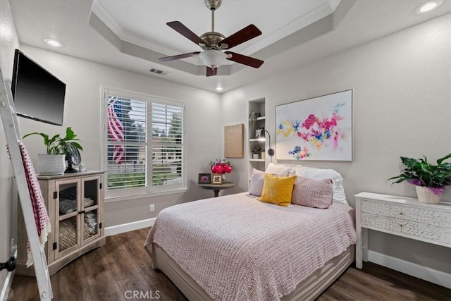 bedroom with a raised ceiling, ceiling fan, dark hardwood / wood-style flooring, and crown molding