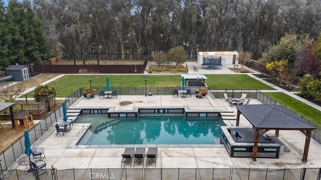 view of swimming pool with a storage shed, a gazebo, a lawn, and a patio