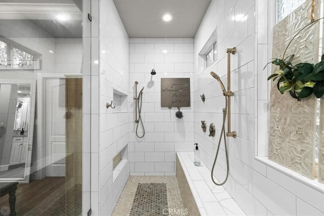 bathroom featuring tile patterned flooring and a tile shower