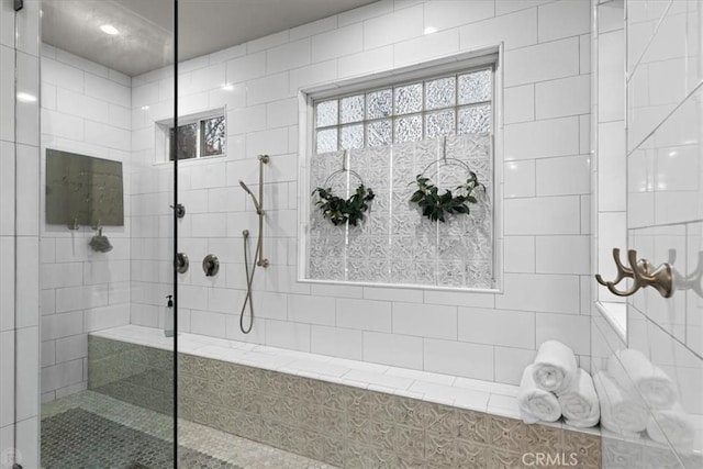 bathroom with tiled shower