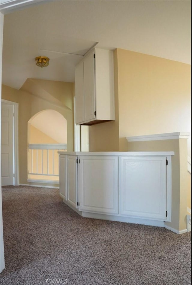 hallway featuring light colored carpet