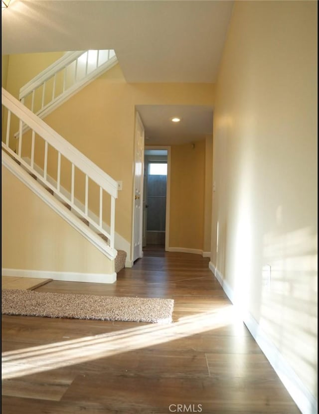 stairway with hardwood / wood-style flooring