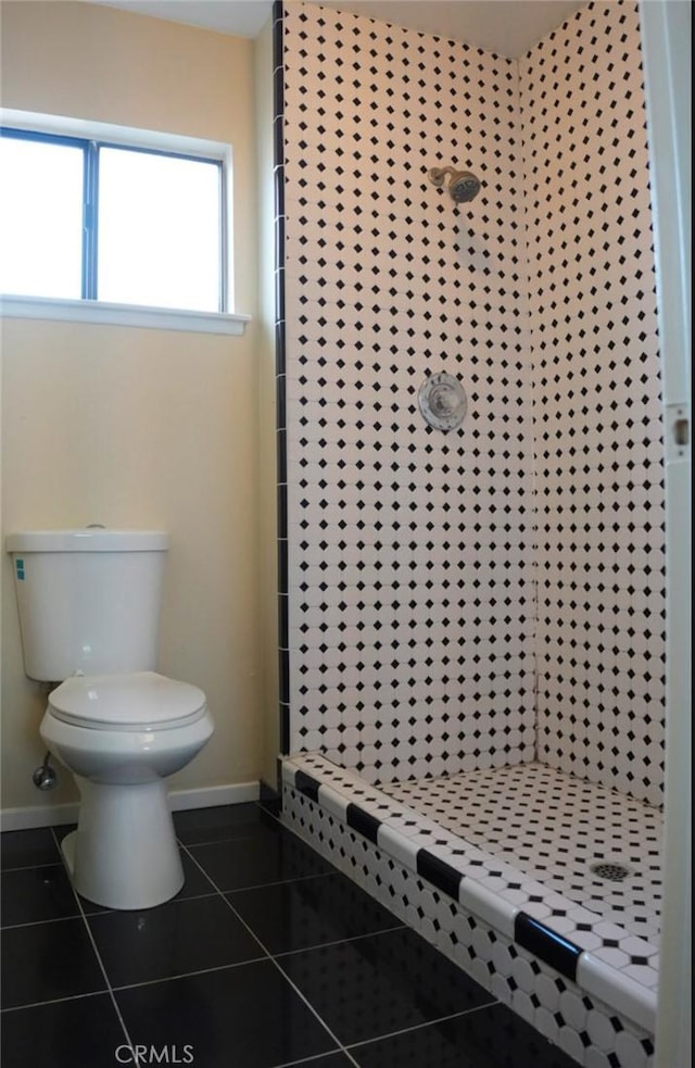 bathroom with a shower, toilet, and tile patterned flooring