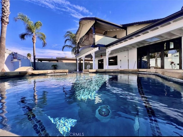 view of pool at dusk