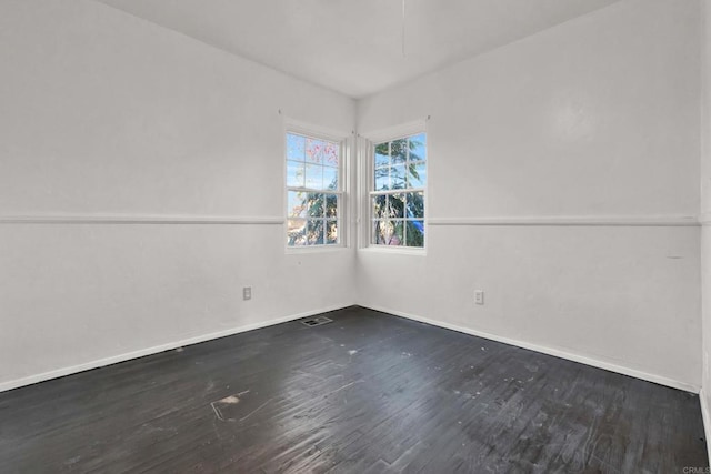 unfurnished room featuring dark wood-type flooring