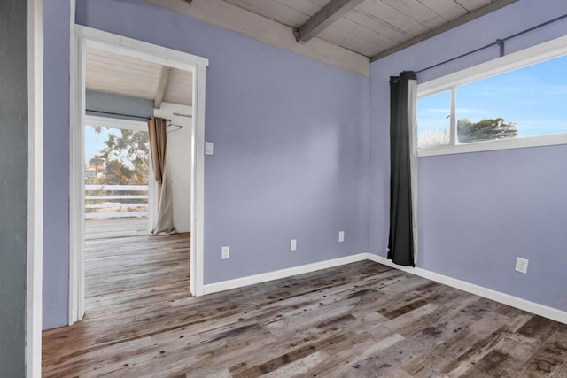 empty room with lofted ceiling with beams, hardwood / wood-style floors, and wooden ceiling