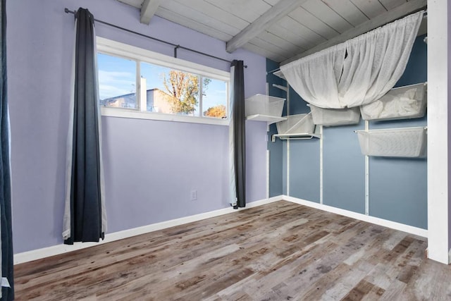 unfurnished bedroom featuring hardwood / wood-style flooring, wood ceiling, and beam ceiling