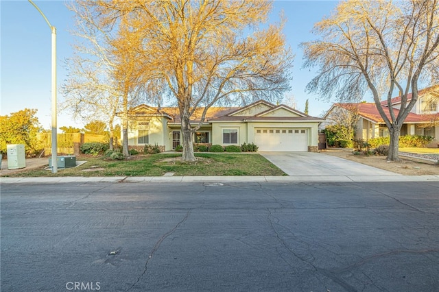 view of front of property with a garage and a front yard