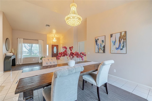 dining area featuring an inviting chandelier and tile patterned floors