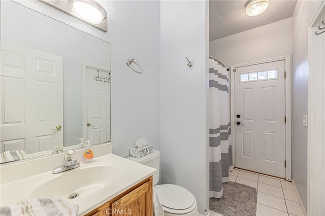 bathroom with vanity, tile patterned floors, and toilet