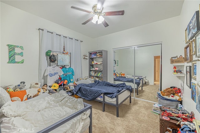 carpeted bedroom featuring ceiling fan and a closet