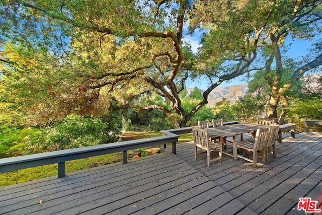 wooden deck with a mountain view