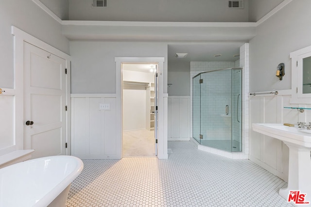 bathroom featuring tile patterned floors, separate shower and tub, and sink