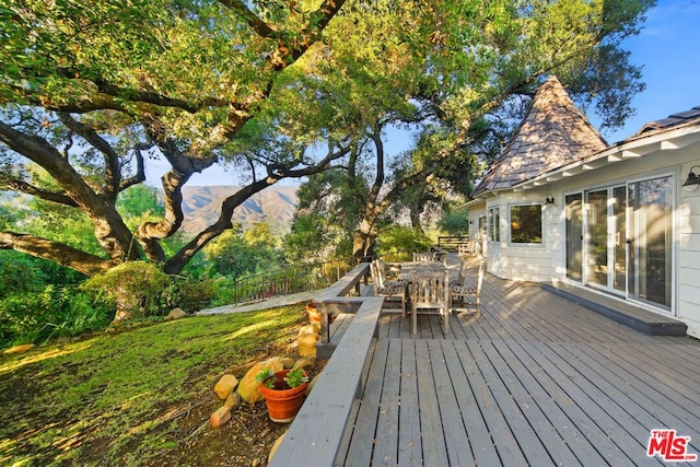 wooden deck with a mountain view