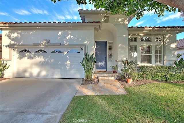 mediterranean / spanish house featuring a front lawn and a garage